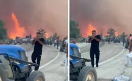 Alevlerin ortasında tepki çeken görüntüler! Orman kül olurken, o sigara yaktı