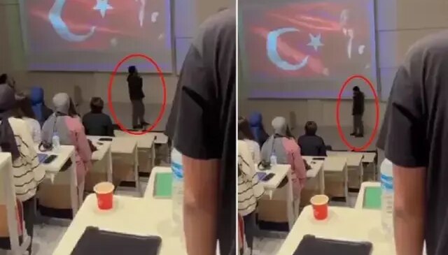 Saat 9’u 5 geçe herkes saygı duruşunda bulunurken, o telefon elinde volta attı