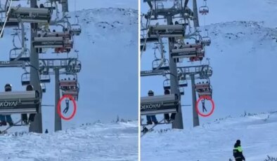 Düşen snowboardını almak için atlamaya çalıştı, telesiyejde asılı kaldı