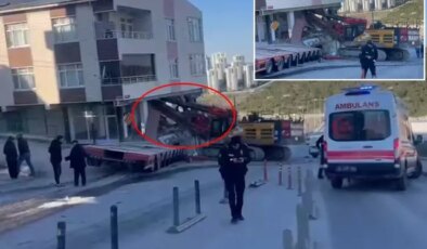 Yokuştan kayan iş makinesi apartmana daldı