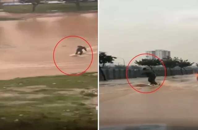 Suyla dolan caddede sörf yaptı