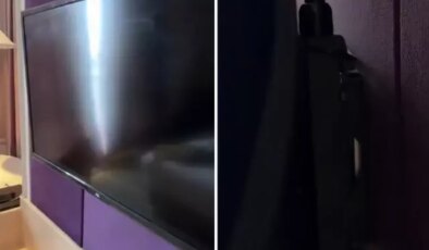 Otel odasında, televizyonun arkasına bakan adam, hayatının şokunu yaşadı.